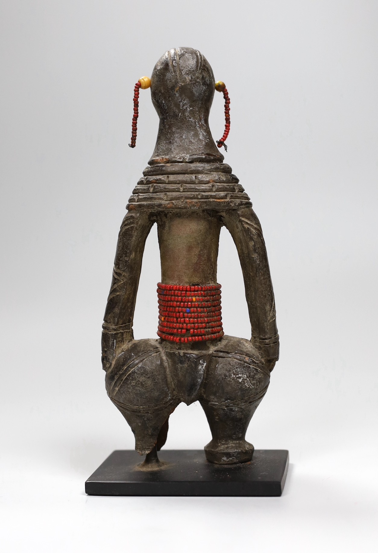 A Benin type cast iron figure. 20.5cm high